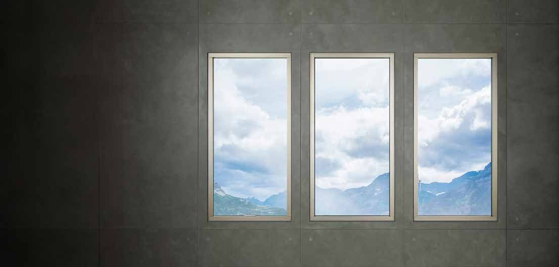 TOSTEM window frame set into a concrete facade with a mountain view