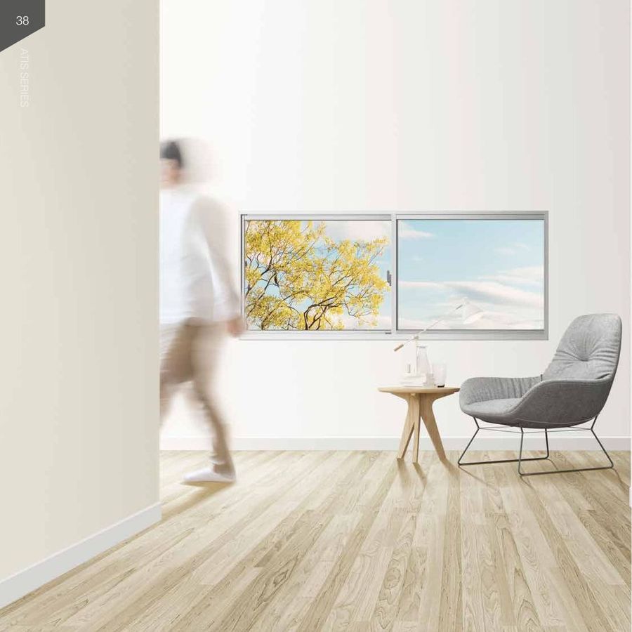 Slim-line aluminium window with an autumn tree view