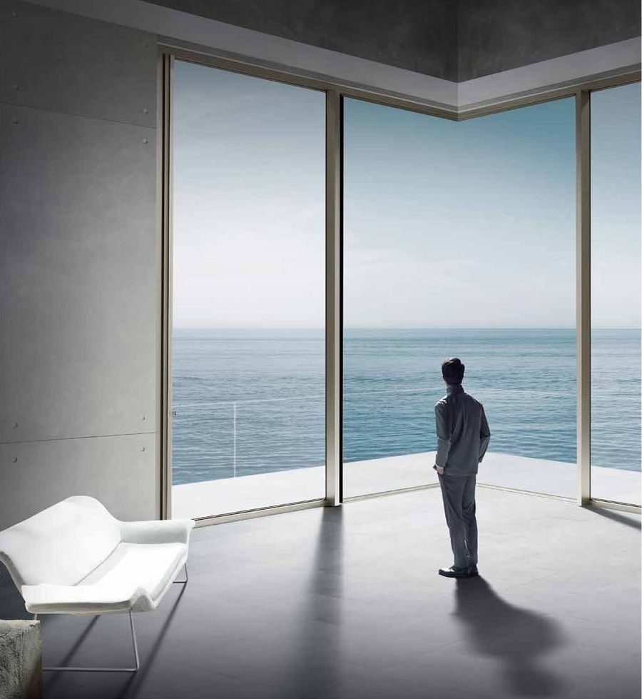 Floor-to-ceiling curtain wall glazing overlooking the sea